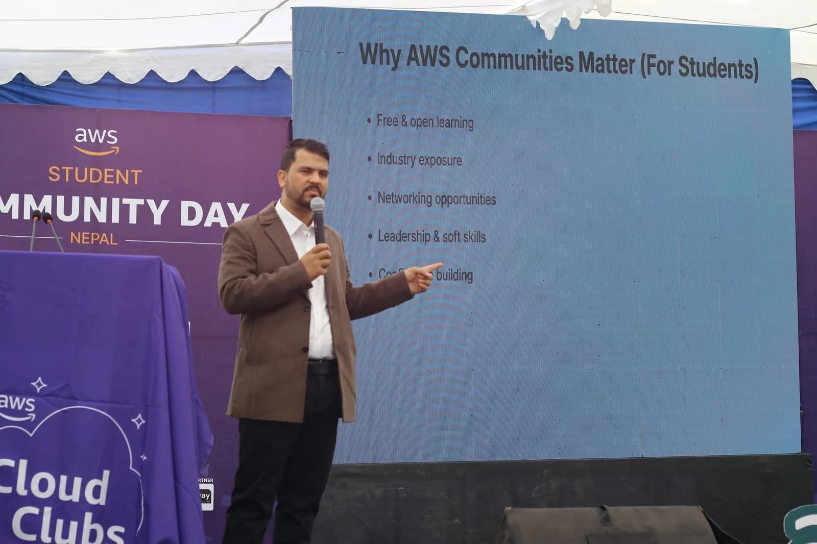 Speaker presenting the talk 'Why AWS Communities Matter (For Students)' at AWS Student Community Day Nepal